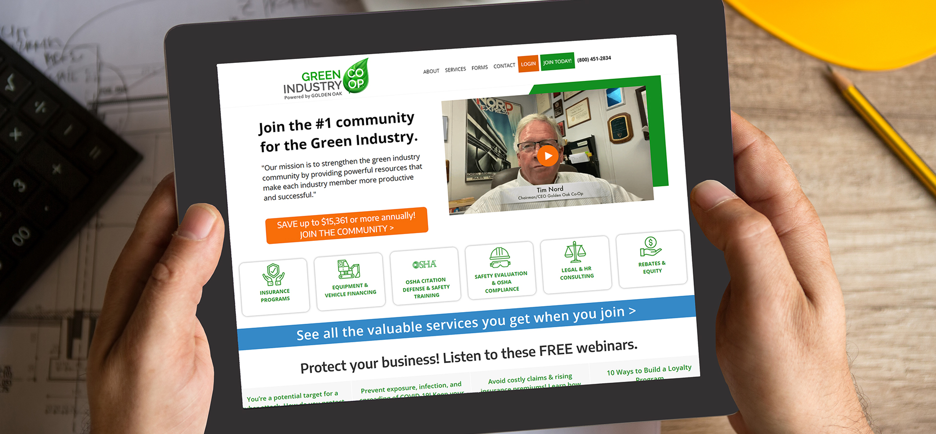 Man Holding Tablet with Green Industry Co-Op Website on the Screen
