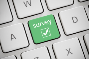 Survey key on a keyboard highlighting a green button labeled 'survey' to showcase how to conduct effective market research.